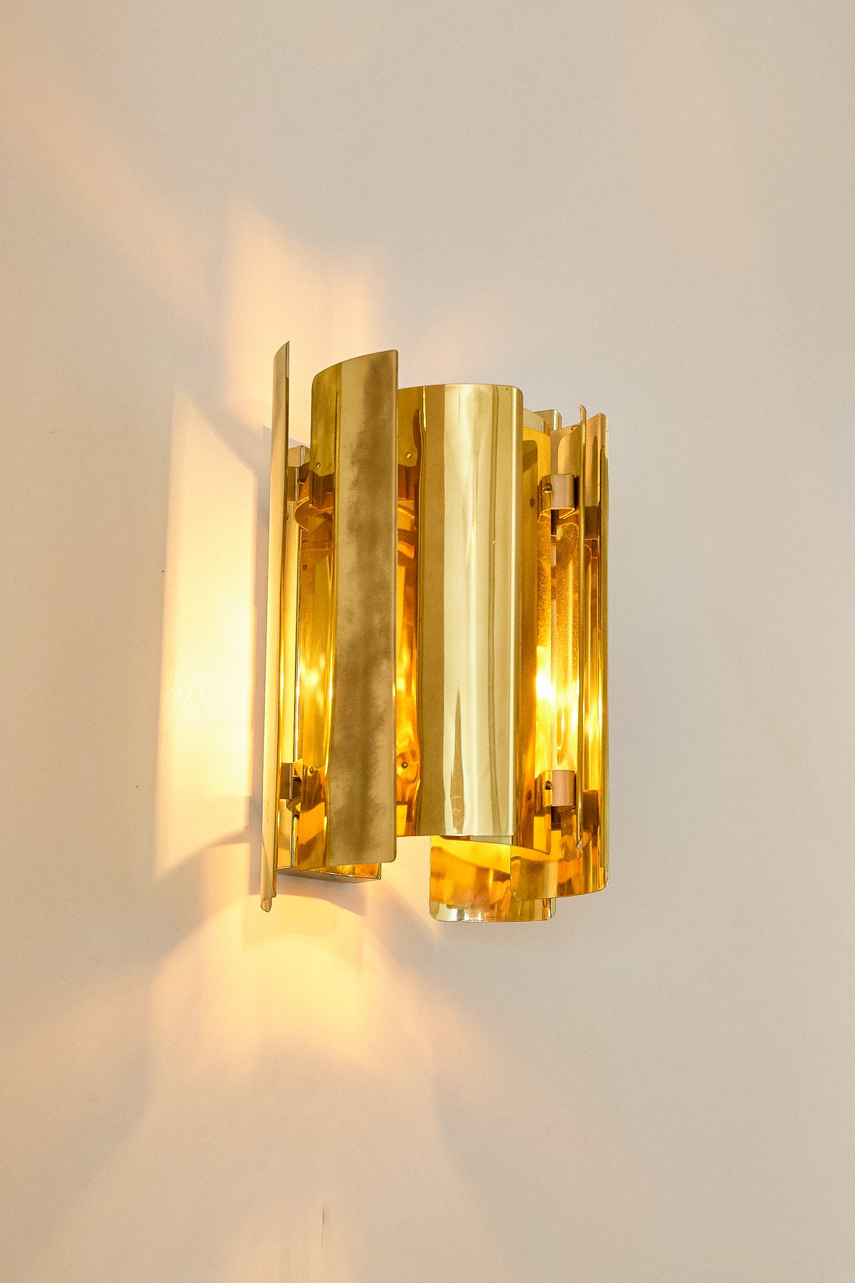 Falkenbergs Belysning brass sconce, angled view of the brass sheets and the light inside