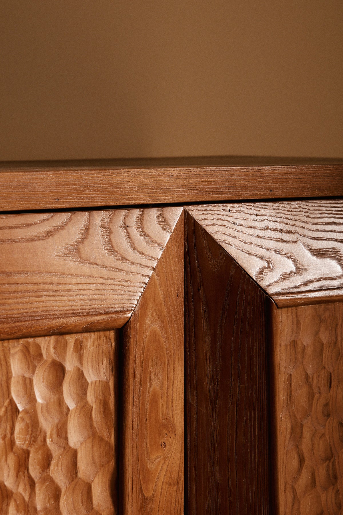 Italian hand carved wood sideboard, close-up of the carved doors and top edge