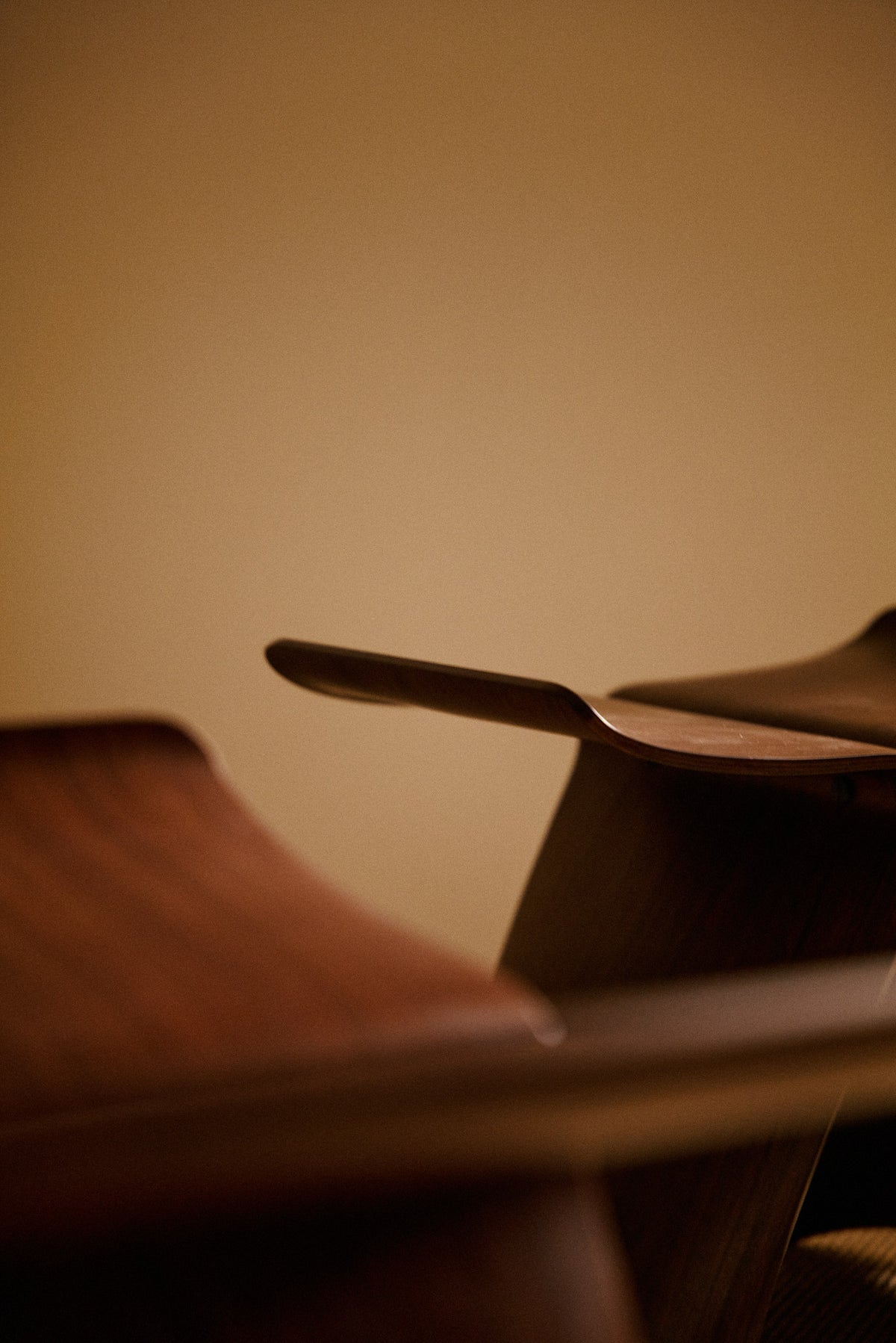 Pair of Sori Yanagi molded rosewood Butterfly stools, close view of the seats