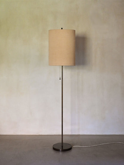 brass and fabric "Trottola" floor lamp, full view, brass stem and fabric shade