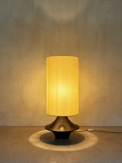 bronze lamp with parchment shade, lit, the parchment shade glowing