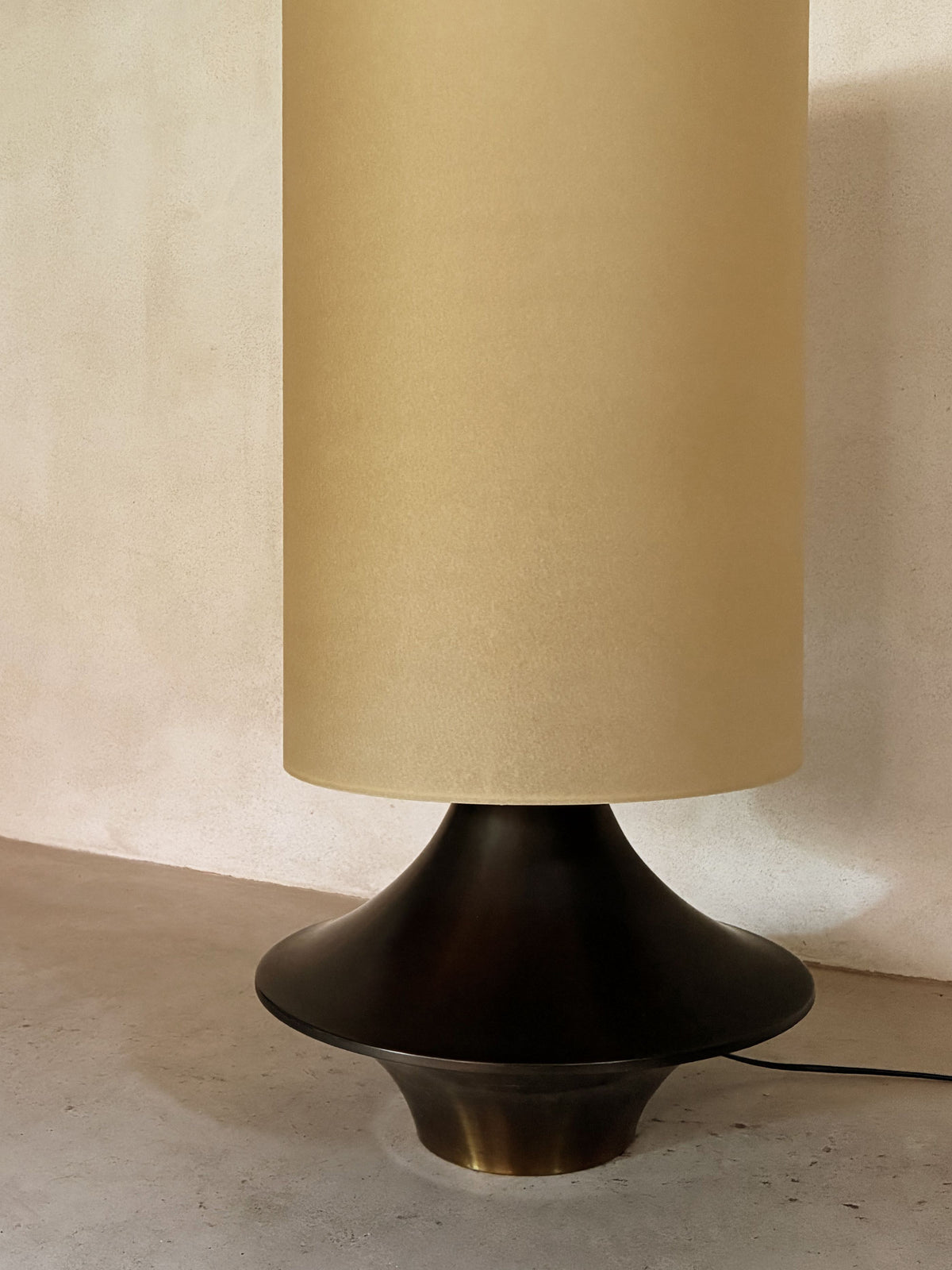 bronze lamp with parchment shade, detail of the flared bronze base, unlit