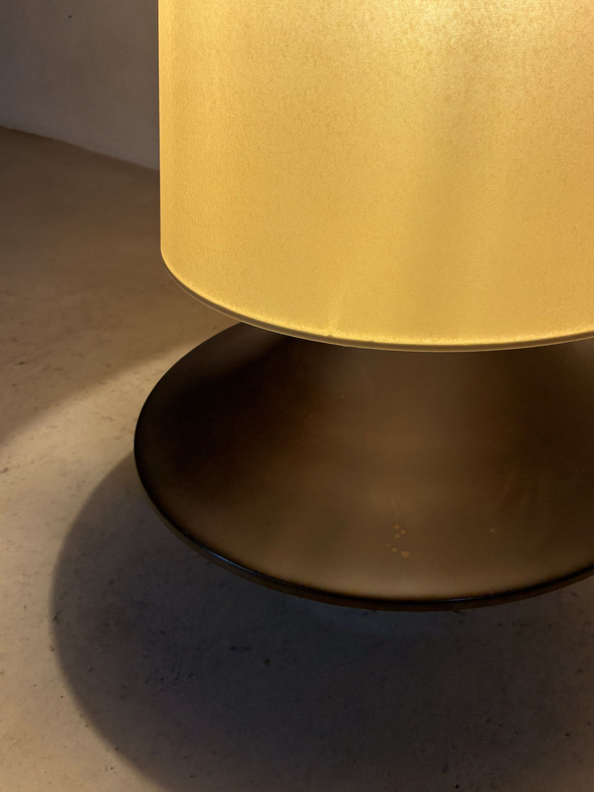 bronze lamp with parchment shade, detail of the base lit from above
