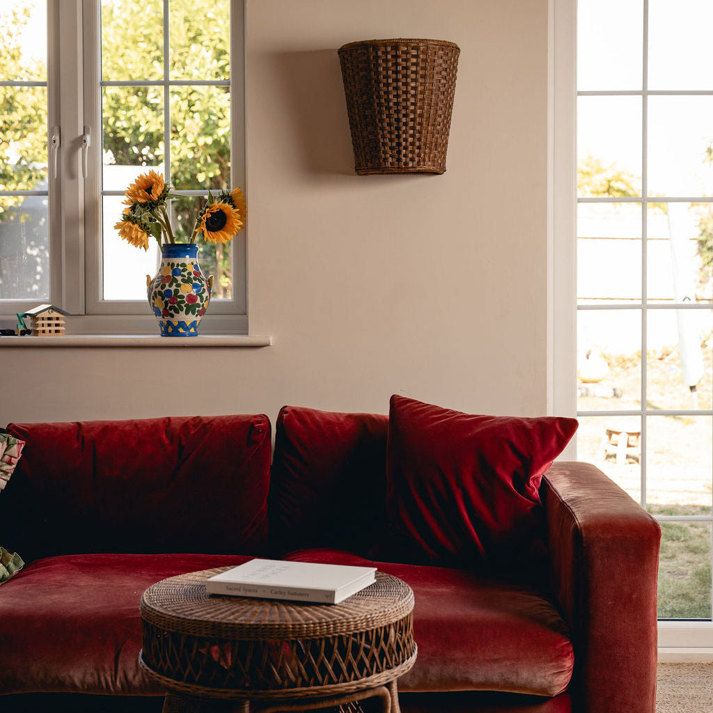 Evelyn Wall Light Shade, Teak, mounted above a sofa in a living room
