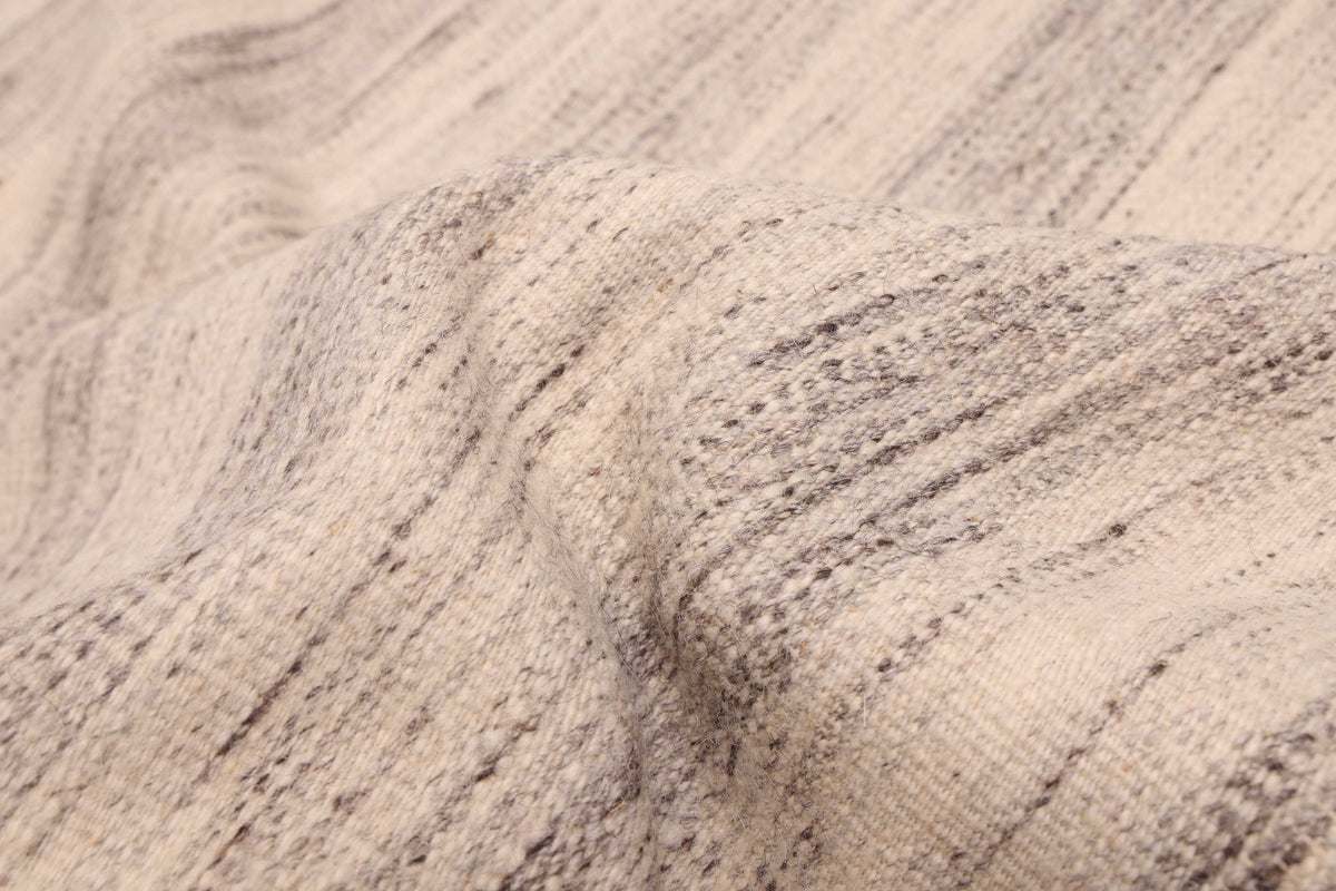 Flat-weave Rug in Sand, folded to show the flat weave