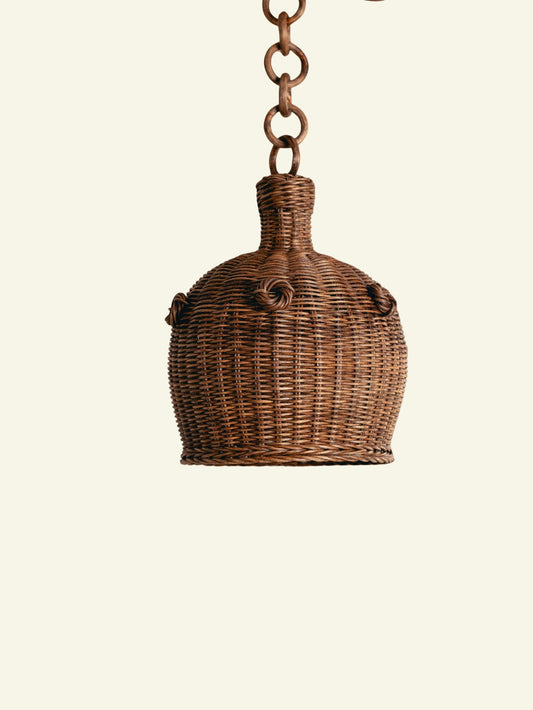 Heather Rattan Pendant Shade, Small, front view on a plain ground, hanging from its rattan chain