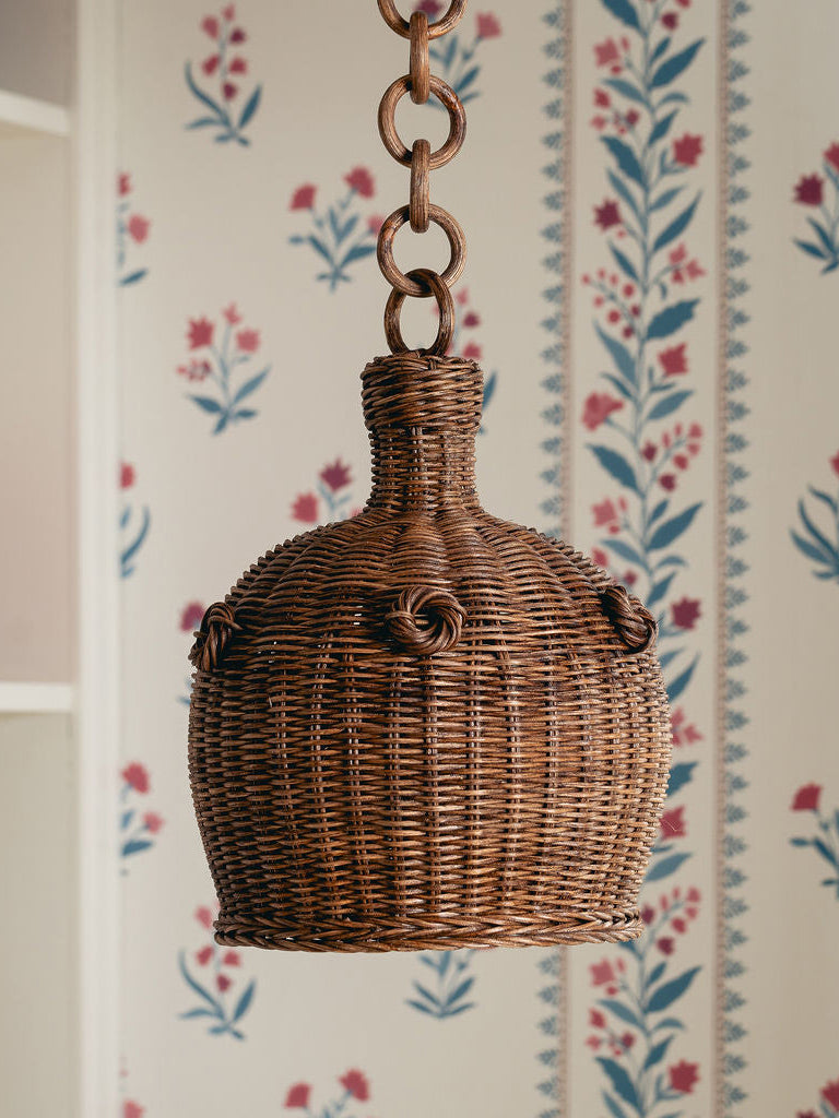 Heather Rattan Pendant Shade, Small, hanging against a floral wallpaper