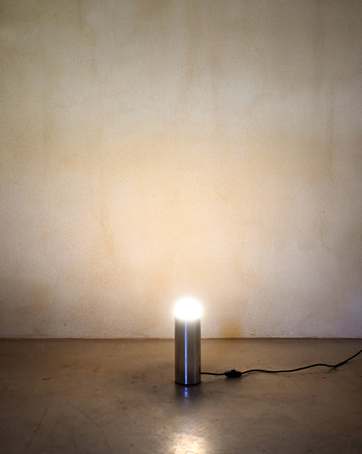 Enrico Tronconi chrome table lamps, pair, a single lamp lit, casting light on the floor and wall