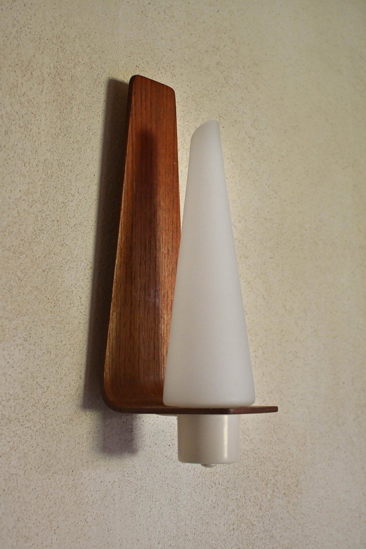 "Pinetti" wood and frosted glass sconce, a single sconce, three-quarter view of wood and glass