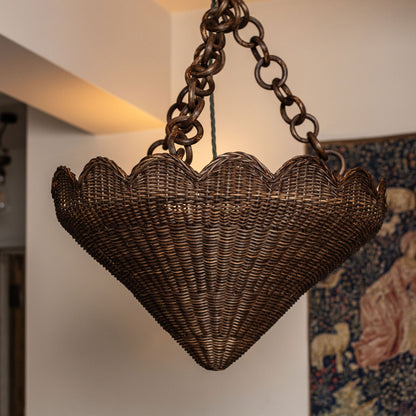 Primrose Rattan Pendant Shade, hanging in a room, lit from the side