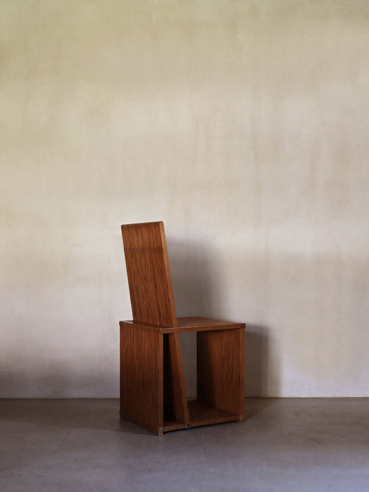 Brutalist wood Strips occasional chair, three-quarter view showing the slatted side panel and seat