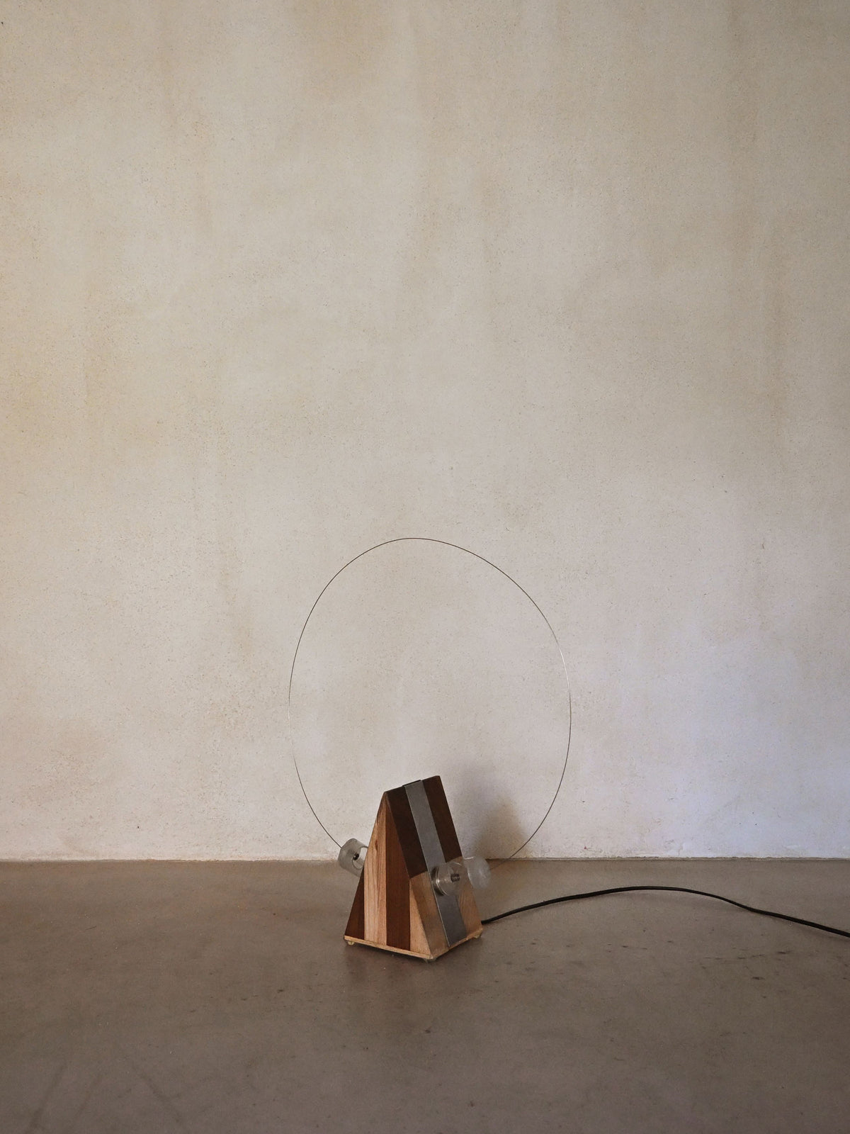Studio A.R.D.I.T.I. "BT1972" lamp, unlit, seen from a lower angle with the wire hoop behind