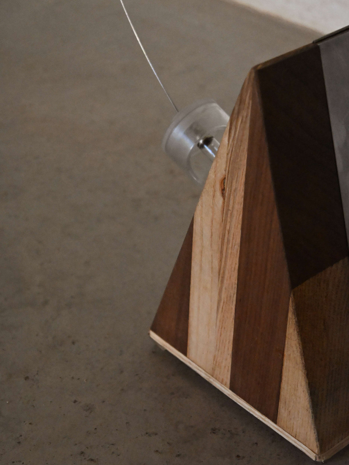 Studio A.R.D.I.T.I. "BT1972" lamp, detail of the striped wood veneer and low-voltage wire