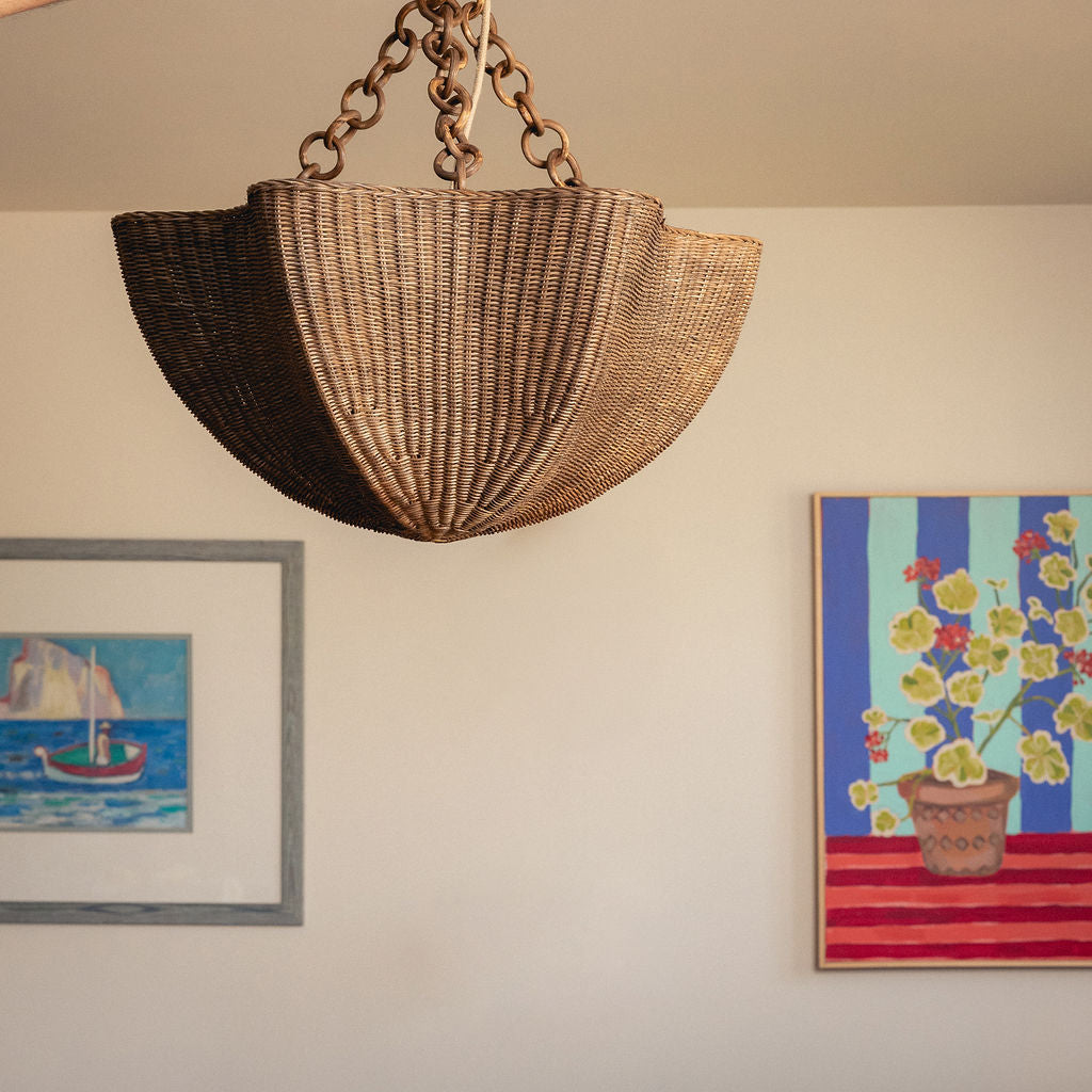 Tallulah Rattan Pendant Shade, Teak, hanging in a room with framed artwork