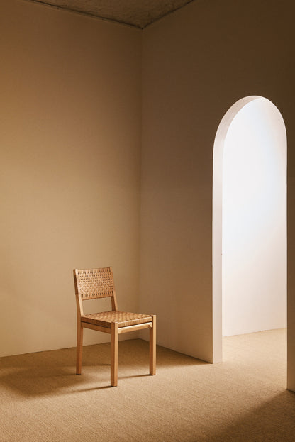 Aino Aalto birch and woven rattan 615 chairs, single chair beside the arched doorway