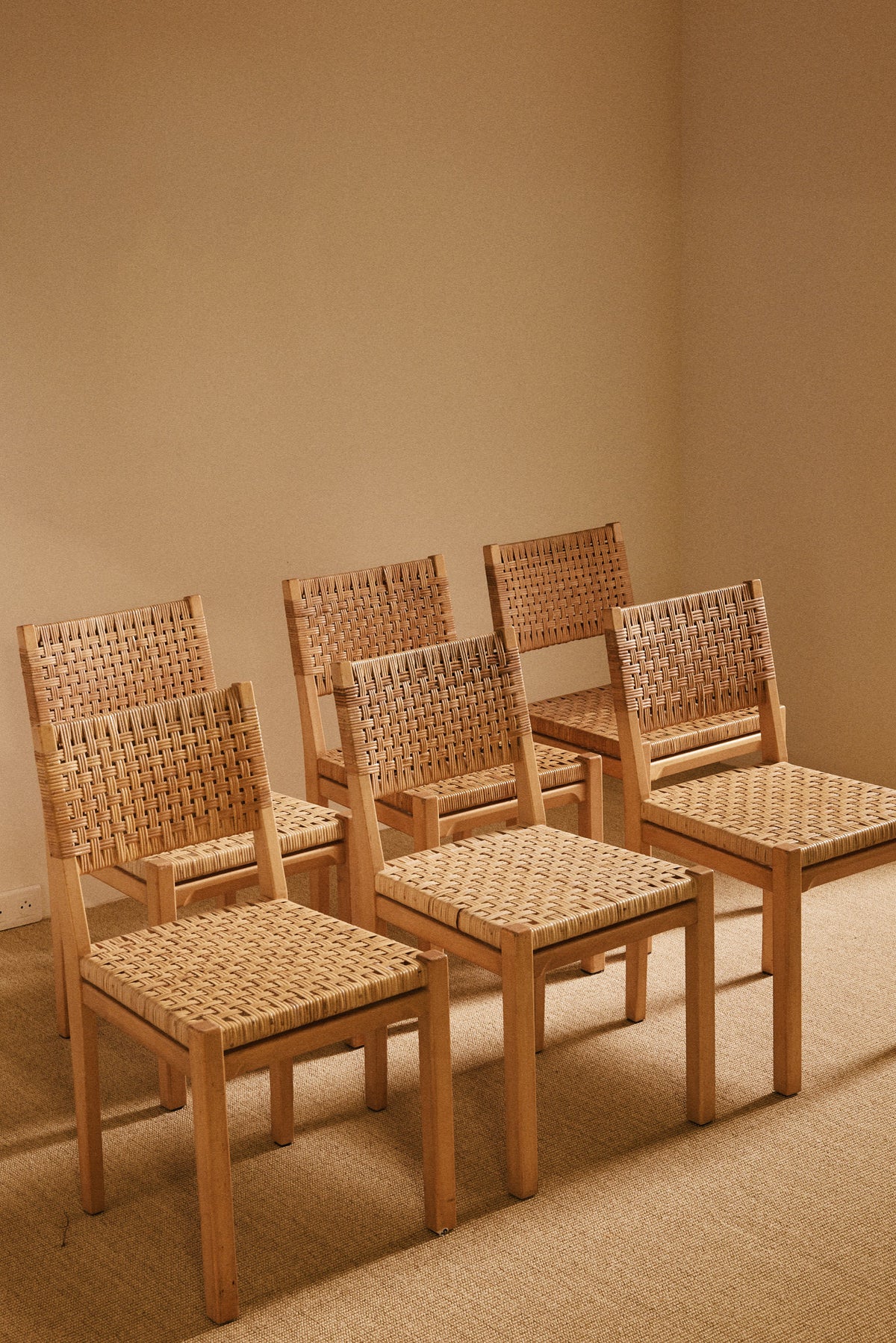 Aino Aalto birch and woven rattan 615 chairs, set of six seen together