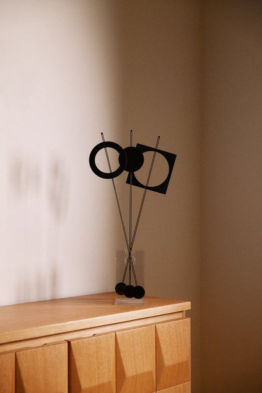 Arnulf Hoffmann kinetic mobile in Plexiglas and black lacquered metal, full view on a wooden cabinet with the ring to the left