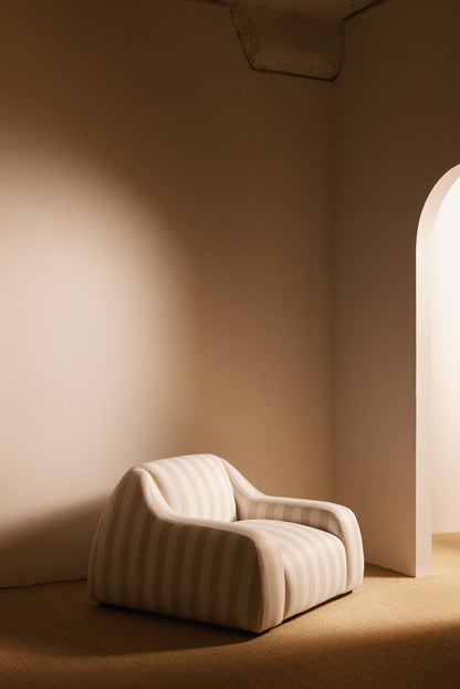 AS02 armchair in Jim Thomson Matelot Sea Shell fabric, angled view in the room by an arched doorway