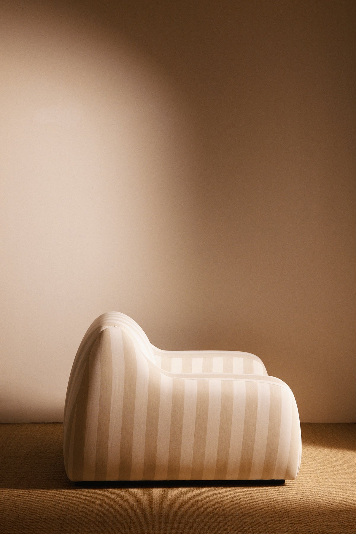 AS02 armchair in Jim Thomson Matelot Sea Shell fabric, side profile showing the rolled back and arm