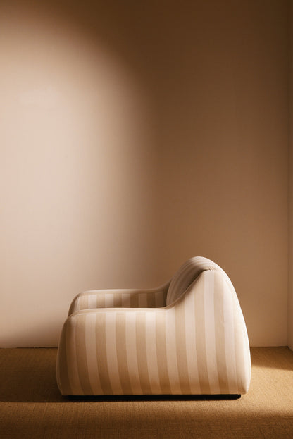 AS02 armchair in Jim Thomson Matelot Sea Shell fabric, side view of the curved back and arm