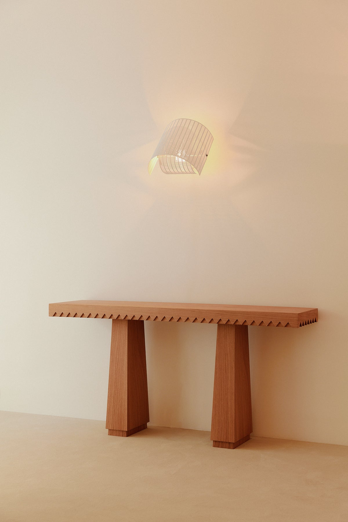 Baga oak console table, front view with a wall light above