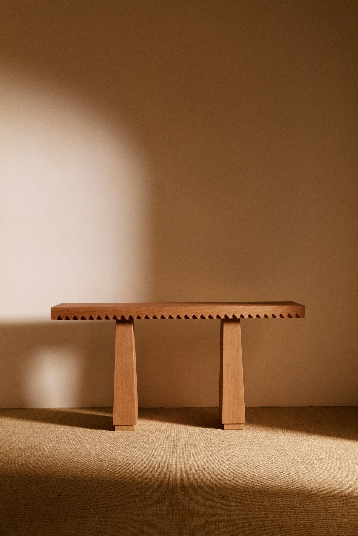 Baga oak console table, front view with the toothed edge
