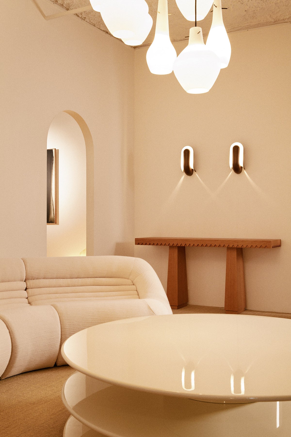 Baga oak console table, view in a living room beside a curved sofa