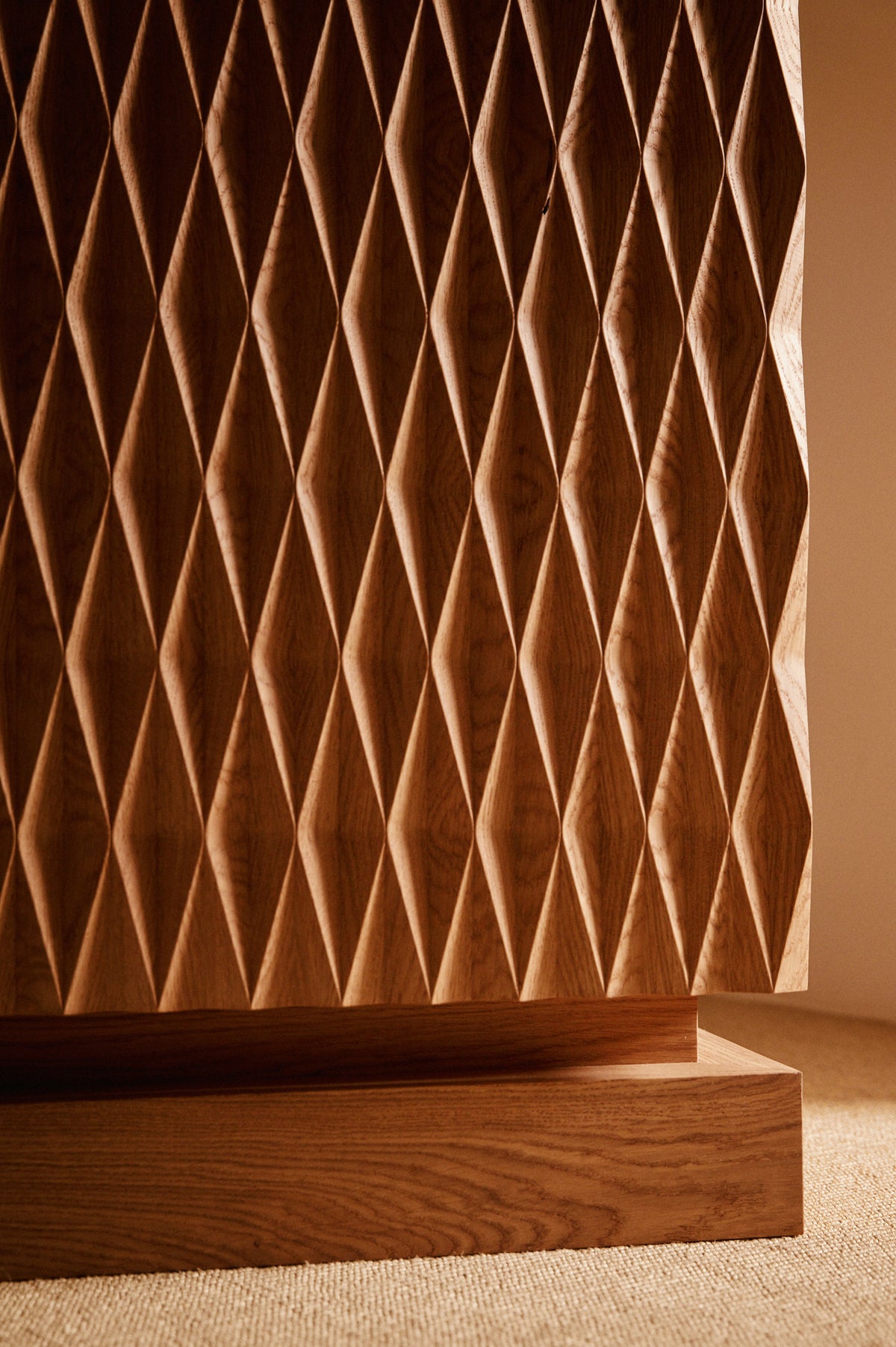 Cabinet 01 in solid oak, close view of the diamond relief and the plinth