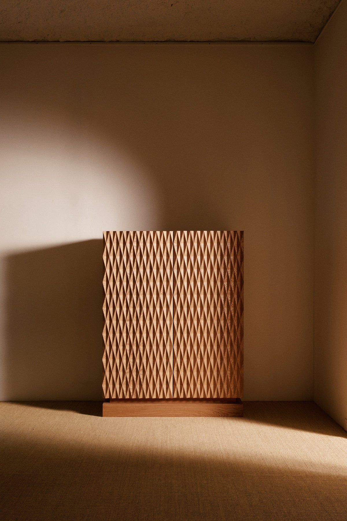 Cabinet 01 in solid oak, front view of the diamond patterned doors