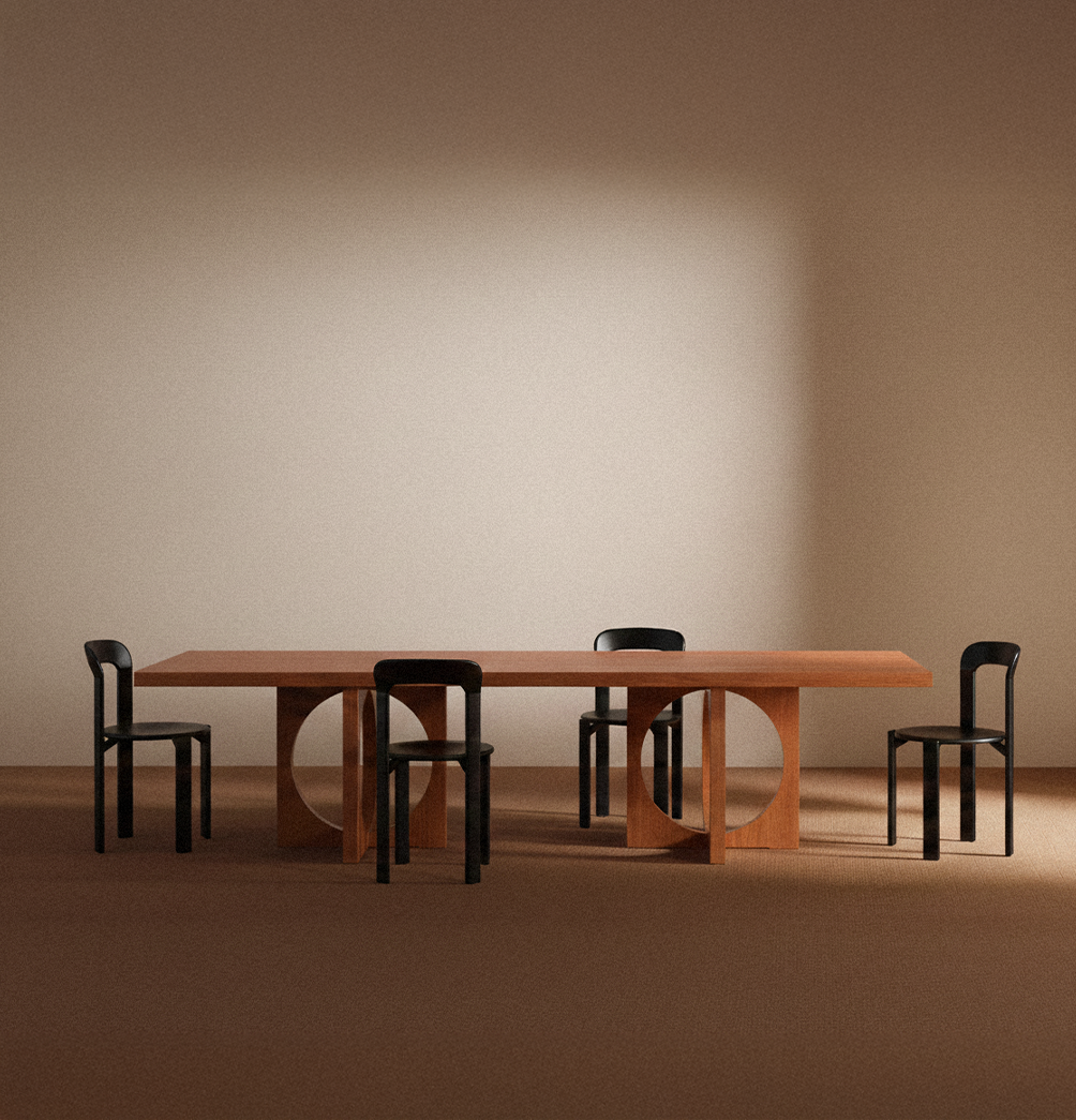 Moon dining table in solid oiled oak, front view with four black chairs around the table