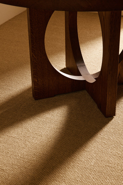 Moon Ronde round dining table in solid oiled oak, close view of a leg with its oval opening