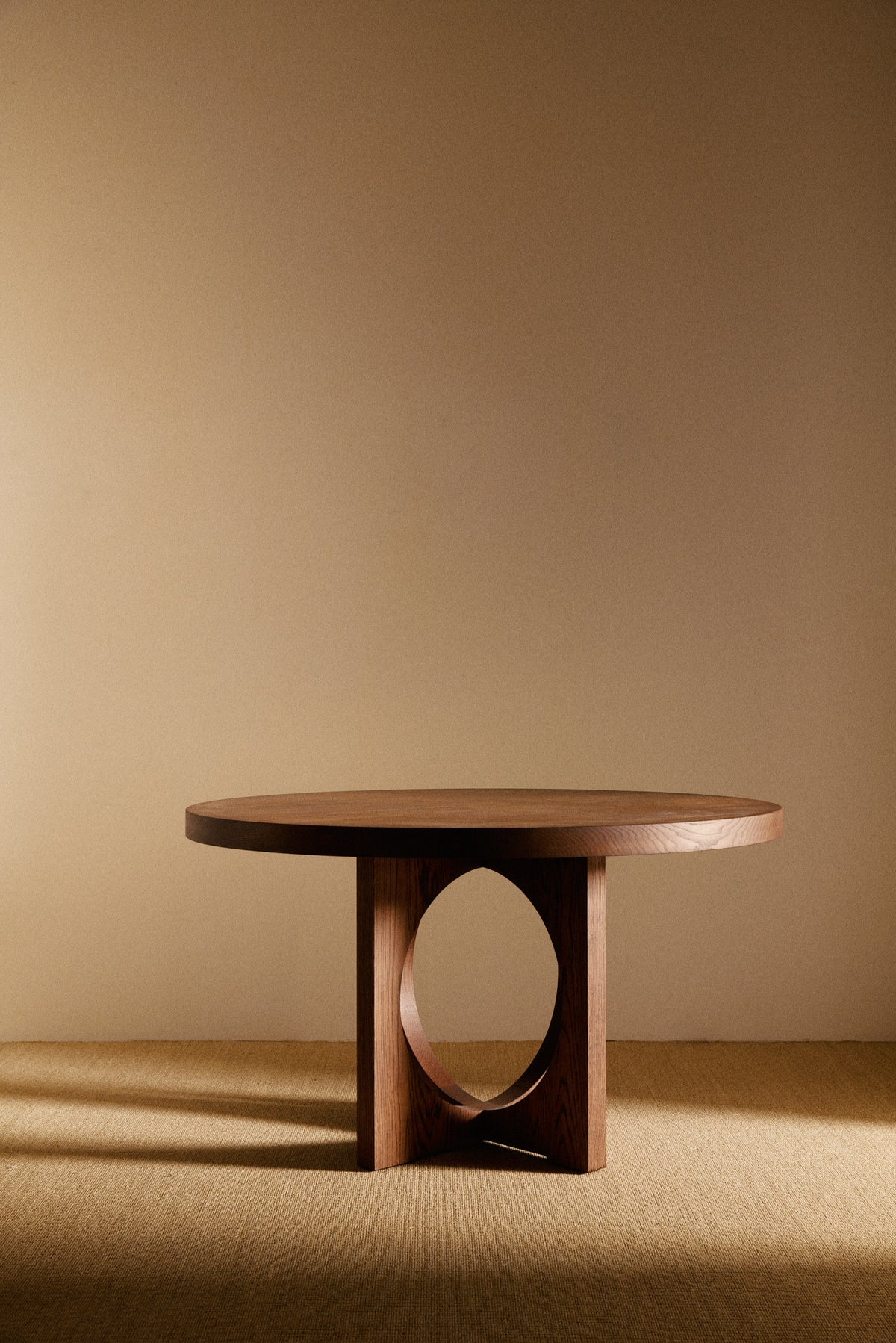 Moon Ronde round dining table in solid oiled oak, wide front view