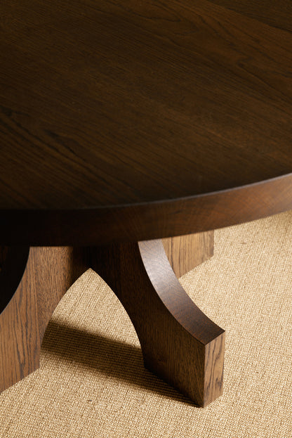Orion round dining table in solid oiled oak, nearer view of the base and top edge in a darker tone