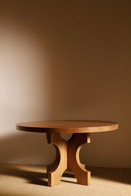 Orion round dining table in solid oiled oak, low front view of the base and top