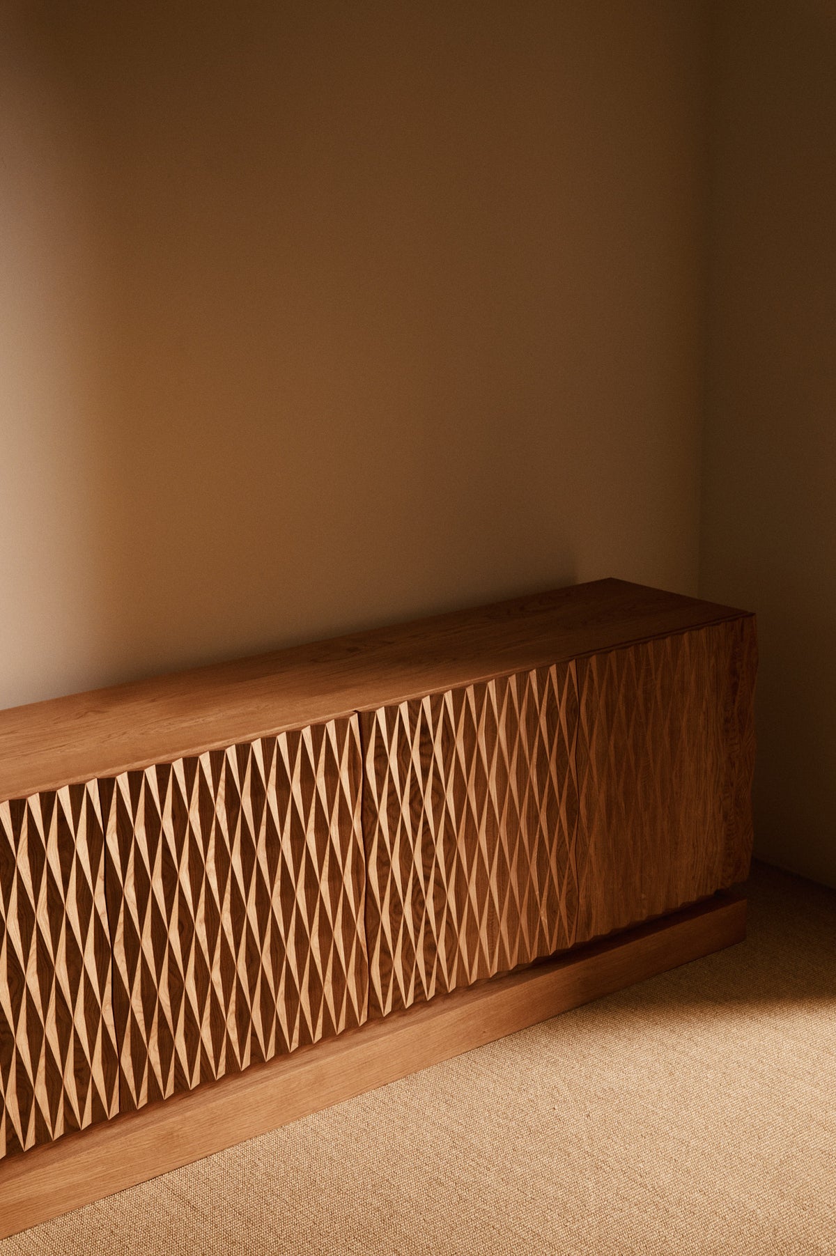 Sideboard 02 in solid oak, angled view of the diamond patterned doors