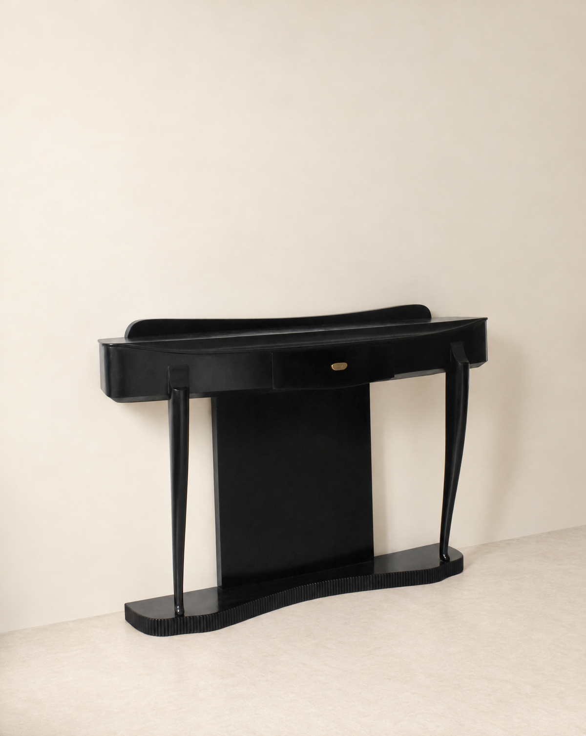 Ebonised console table at an angle showing the curved top and slender legs