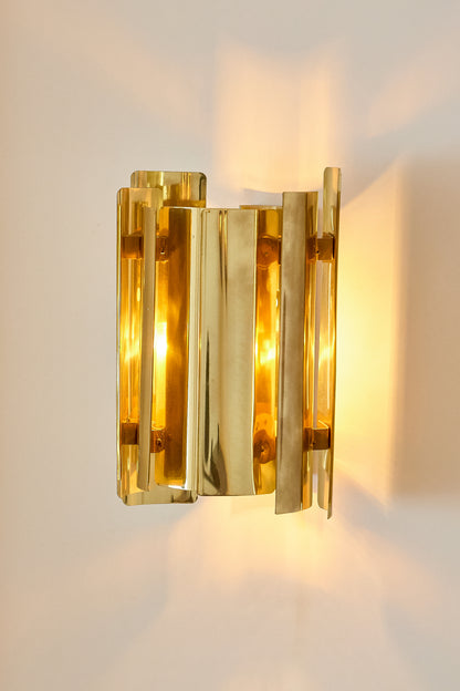 Falkenbergs Belysning brass sconce, nearer view of the lit sconce on the wall