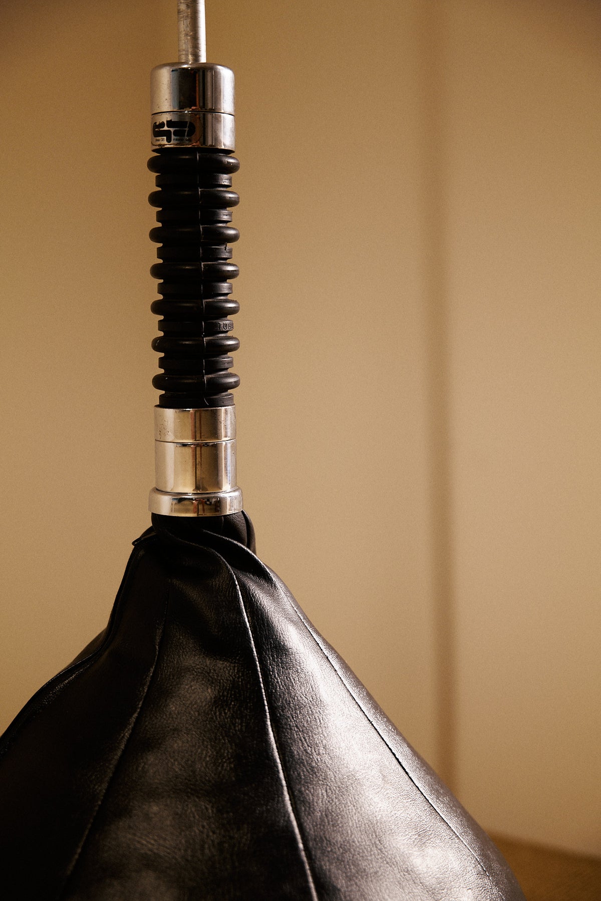 Gabetti & Isola leather and metal floor lamp, close view of the ribbed black collar above the leather base
