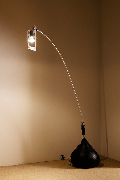 Gabetti & Isola leather and metal floor lamp, wide view with the arm reaching across the corner
