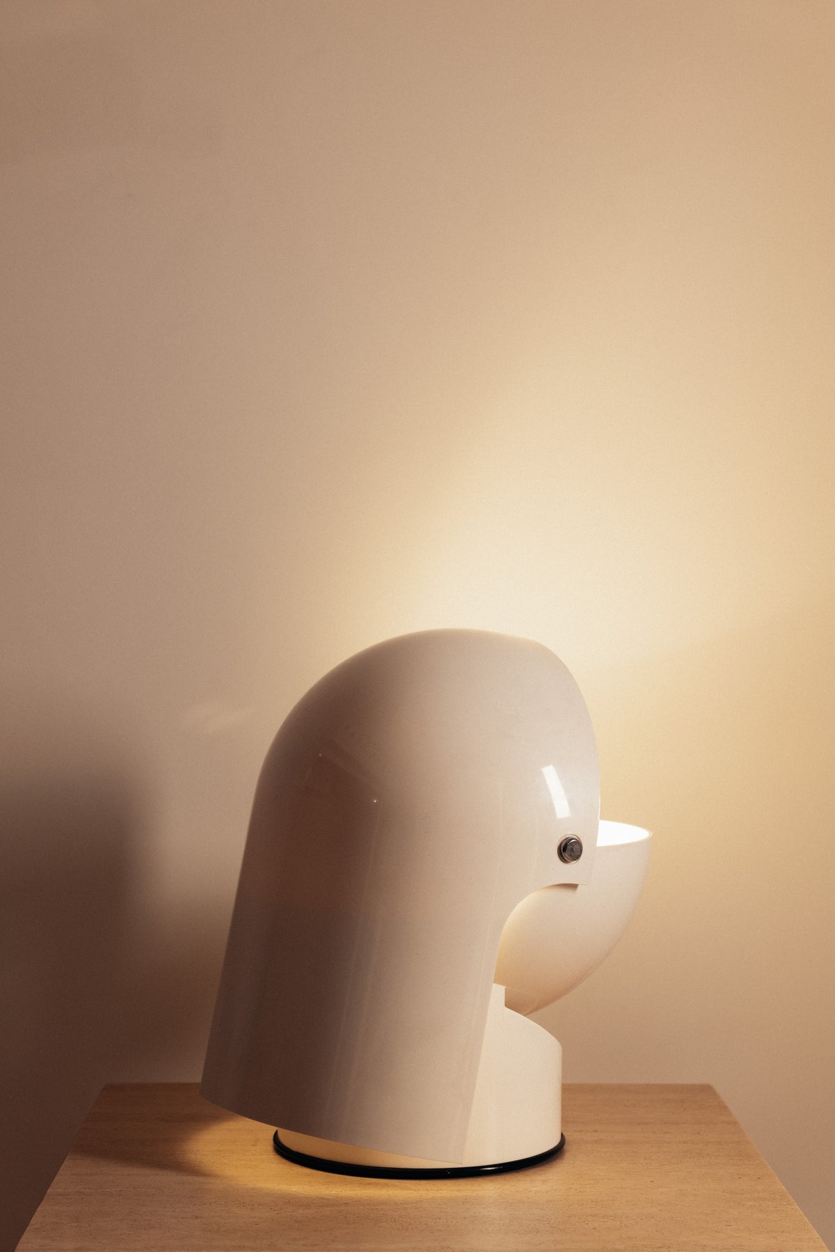 Gae Aulenti molded ABS Mezzo Pileo table lamp, hood tipped forward, angled view