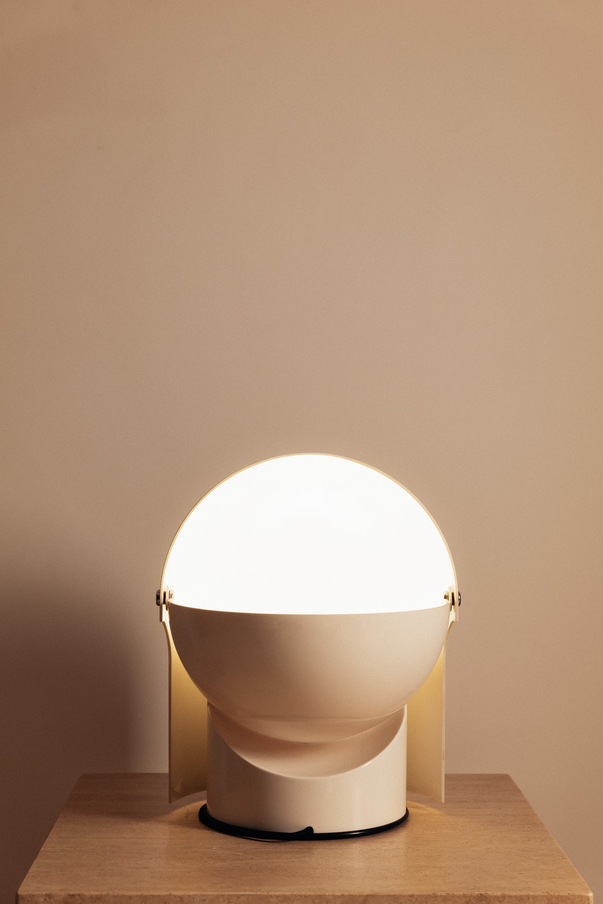 Gae Aulenti molded ABS Mezzo Pileo table lamp, hood open showing the lit globe