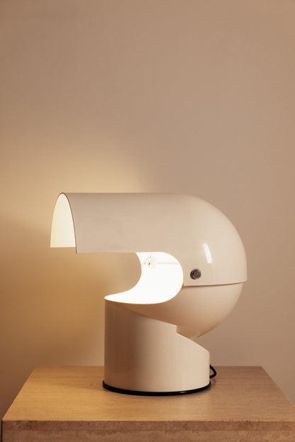 Gae Aulenti molded ABS Mezzo Pileo table lamp, hood open on a stone topped table