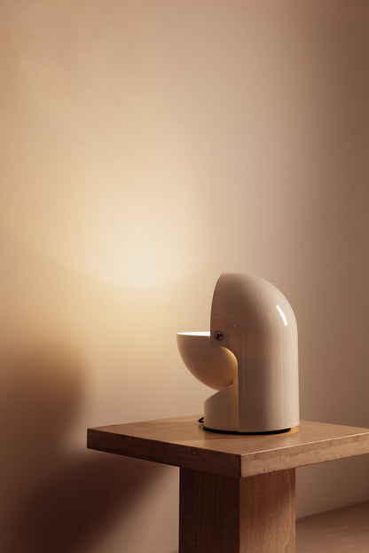 Gae Aulenti molded ABS Mezzo Pileo table lamp, side view on a small table