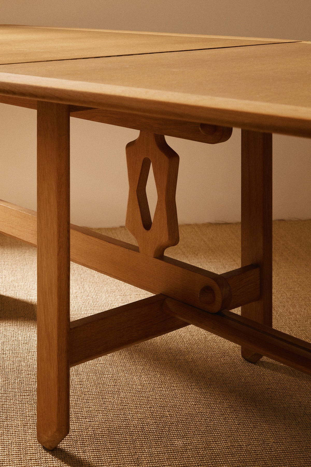 Guillerme & Chambron solid oak folding Wallet dining table, close view of the pierced upright and frame