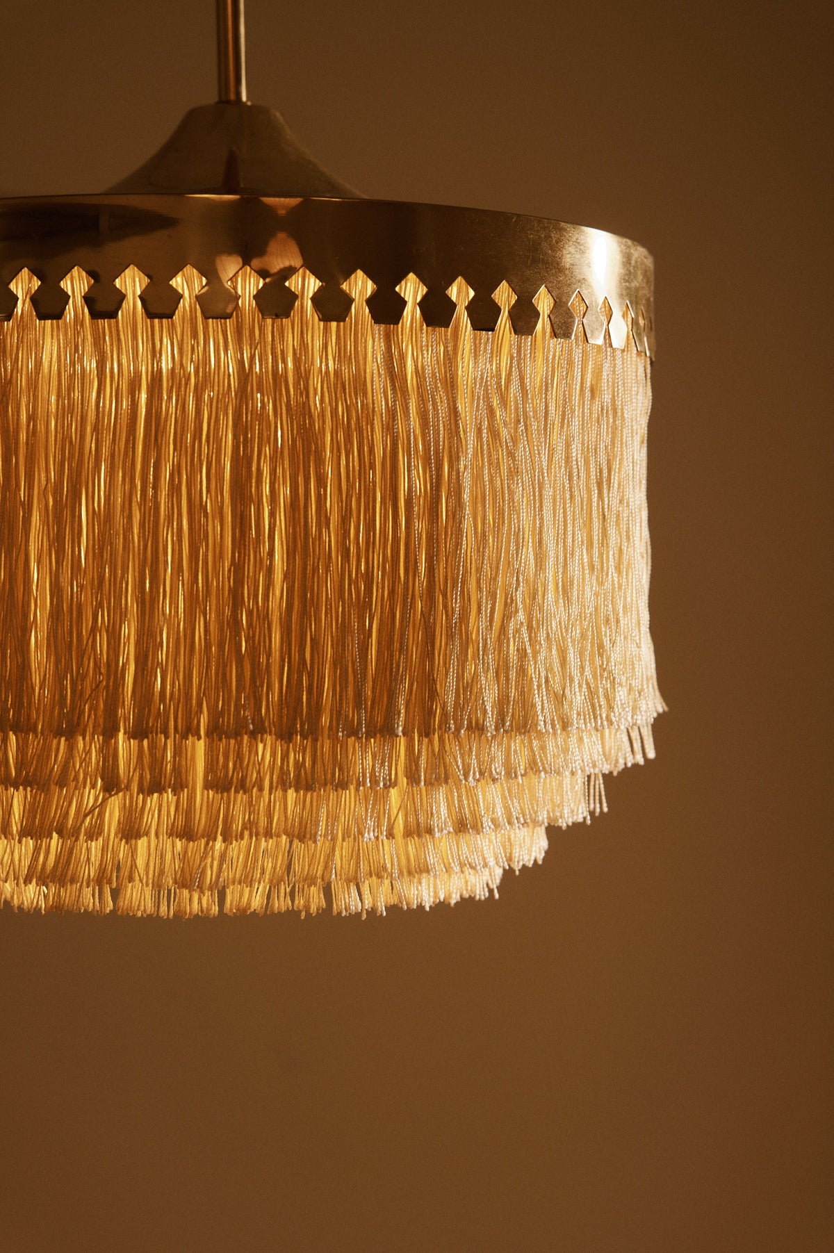 Hans Agne Jakobsson brass and silk pendant lights, close view of the pierced brass crown and silk fringe