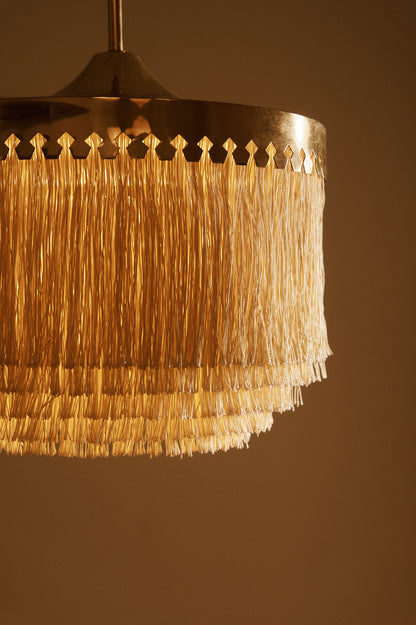 Hans Agne Jakobsson brass and silk pendant lights, close view of the pierced brass crown and silk fringe