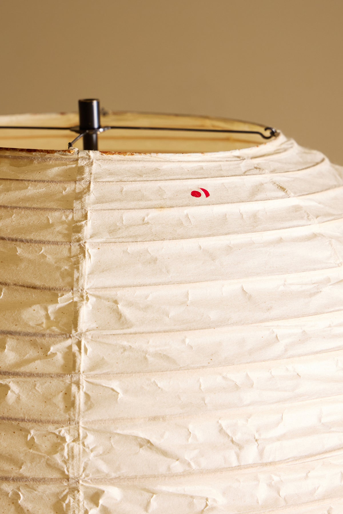 Isamu Noguchi Akari 32N floor lamp, close view of the paper shade with its red mark