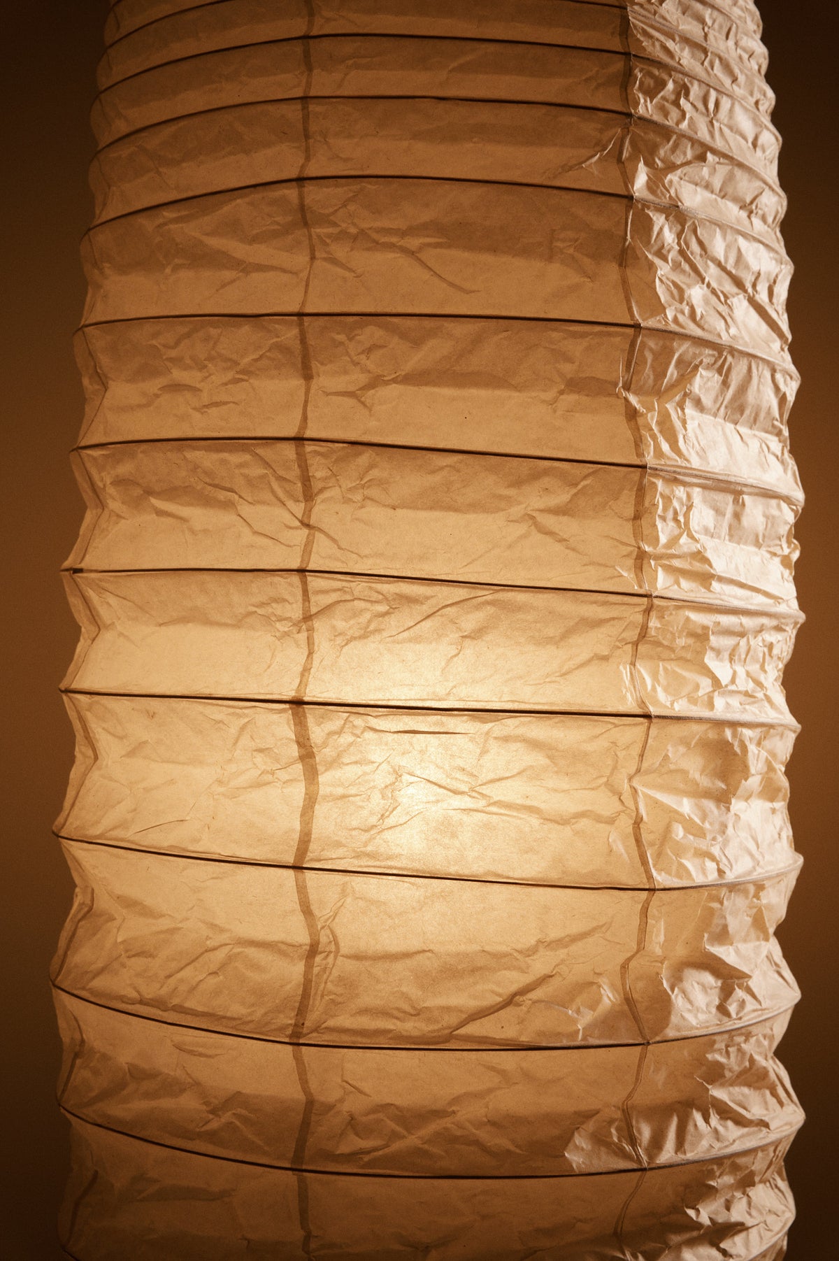 Isamu Noguchi Akari 32N floor lamp, close view of the creased paper shade lit