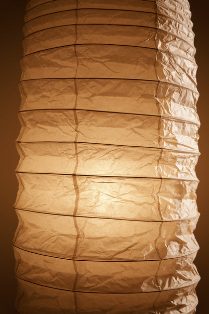 Isamu Noguchi Akari 32N floor lamp, close view of the creased paper shade lit