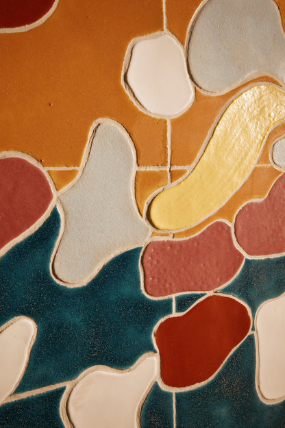 Jan Snoeck ceramic artwork in a wooden frame, close view of the rust and teal glaze